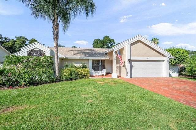 ranch-style house featuring a garage and a front lawn