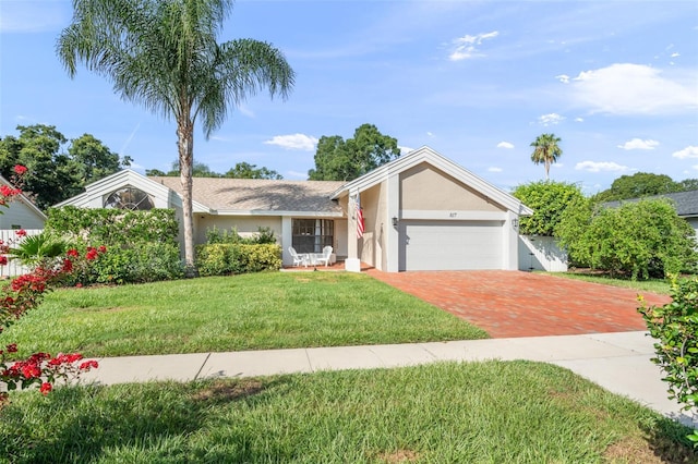 single story home with a garage and a front lawn