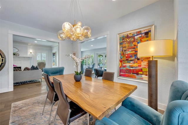 dining space featuring a wealth of natural light, baseboards, a chandelier, and wood finished floors