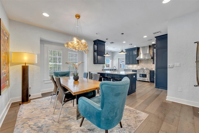 dining room featuring baseboards, recessed lighting, visible vents, and light wood-style floors