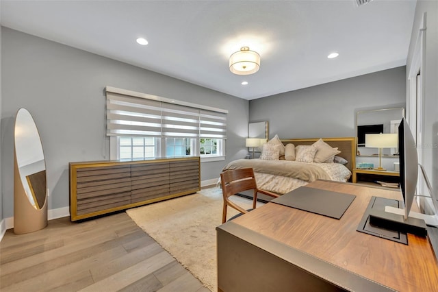 bedroom with light wood finished floors, recessed lighting, and baseboards