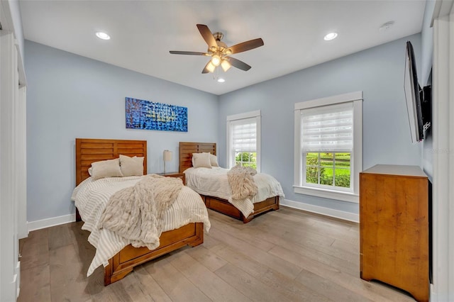 bedroom featuring recessed lighting, light wood-type flooring, and baseboards