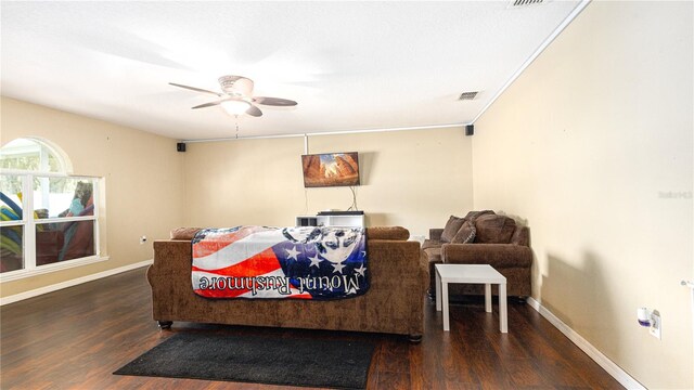 living room with dark wood-type flooring and ceiling fan