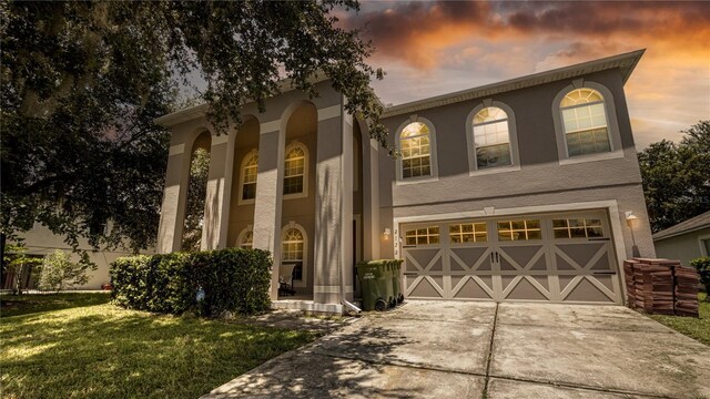 view of front facade featuring a garage and a yard