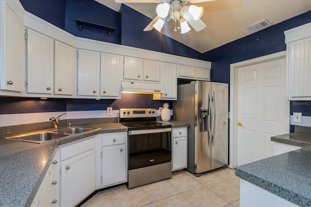 kitchen featuring white cabinets, vaulted ceiling, stainless steel appliances, and sink