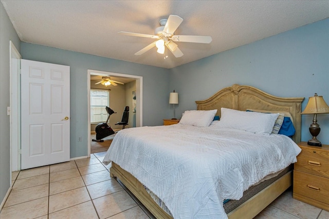 bedroom featuring ceiling fan, light tile patterned flooring, and a textured ceiling