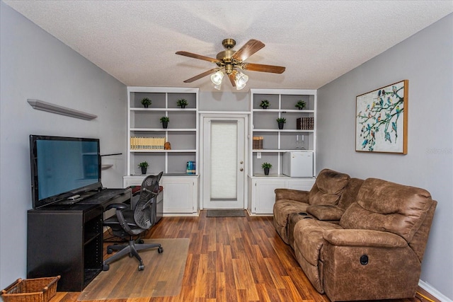 home office featuring a textured ceiling, ceiling fan, and dark wood-type flooring