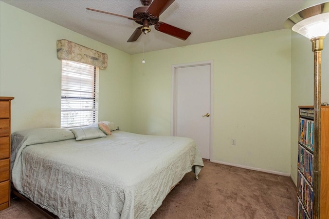 carpeted bedroom with a textured ceiling and ceiling fan