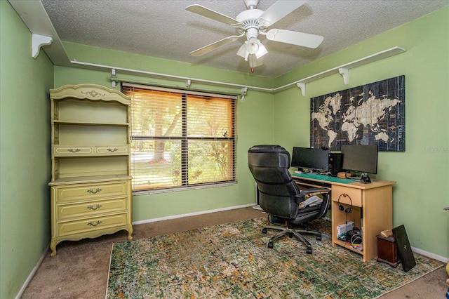 carpeted home office with ceiling fan and a textured ceiling