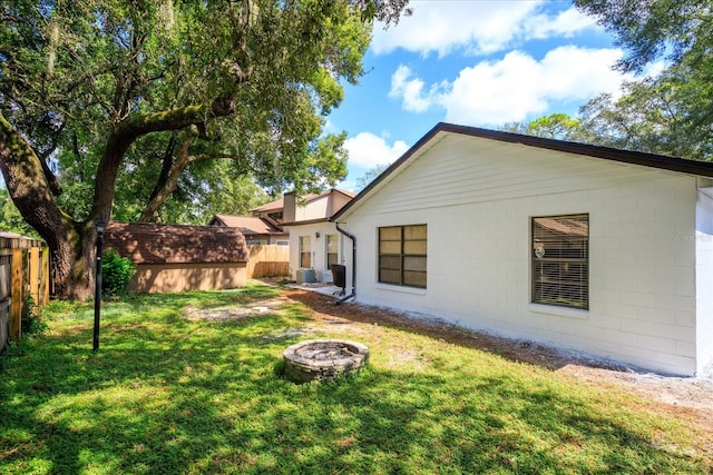 view of yard with a storage shed and a fire pit