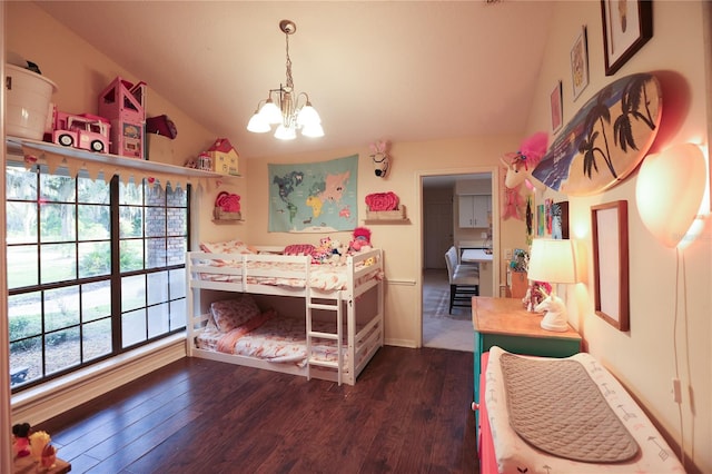 bedroom featuring dark hardwood / wood-style floors, vaulted ceiling, and a chandelier