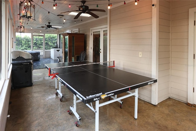 recreation room featuring ceiling fan, concrete floors, and french doors