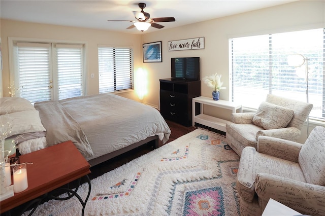 bedroom with ceiling fan, access to outside, hardwood / wood-style flooring, and multiple windows