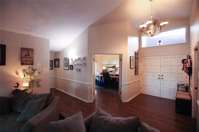 living room featuring high vaulted ceiling, a notable chandelier, and dark hardwood / wood-style floors