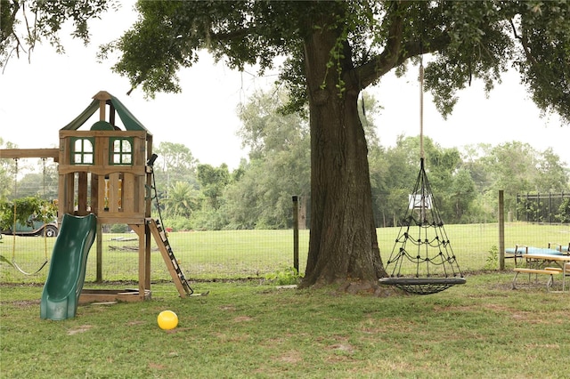 view of jungle gym featuring a lawn