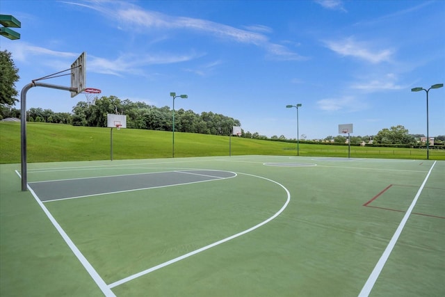 view of basketball court featuring community basketball court and a lawn