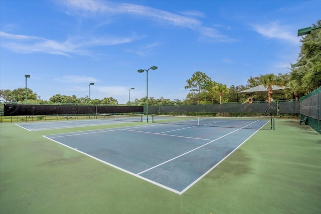 view of tennis court with fence