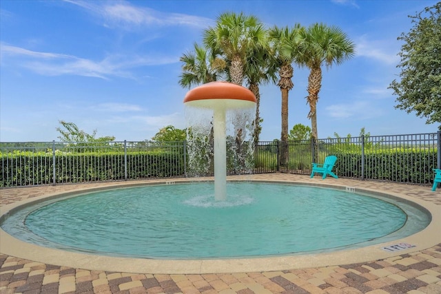 view of swimming pool with fence