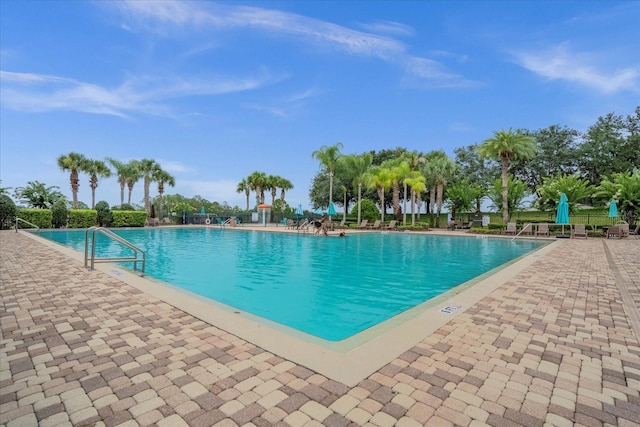 community pool featuring a patio area and fence