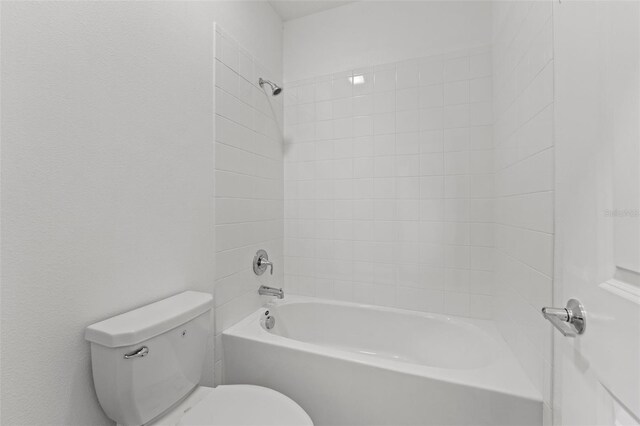 bathroom featuring shower / washtub combination and toilet