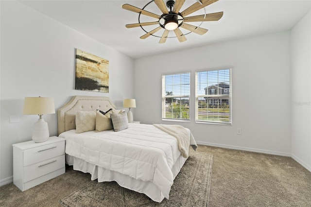 carpeted bedroom with ceiling fan and baseboards