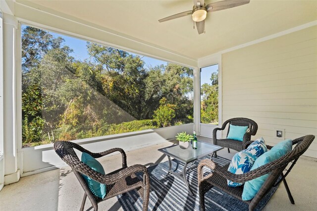 sunroom with a wealth of natural light and a ceiling fan