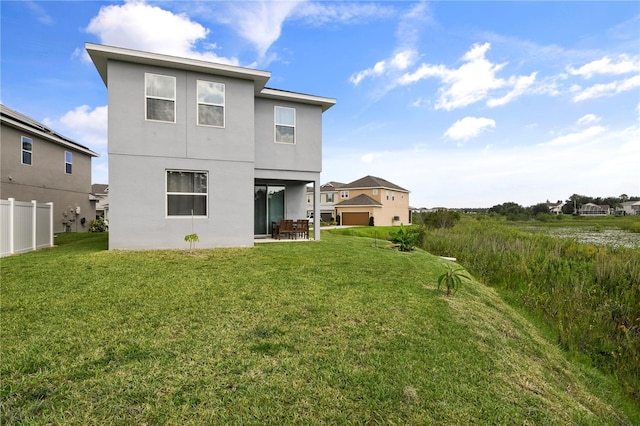 back of property featuring a patio area and a lawn