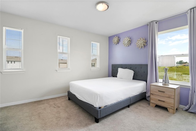 bedroom featuring light carpet