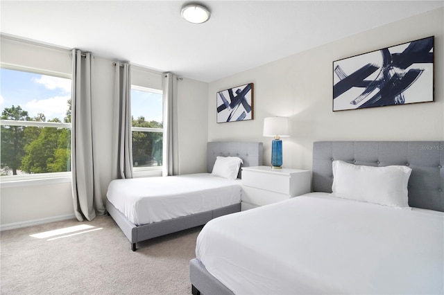 carpeted bedroom featuring multiple windows