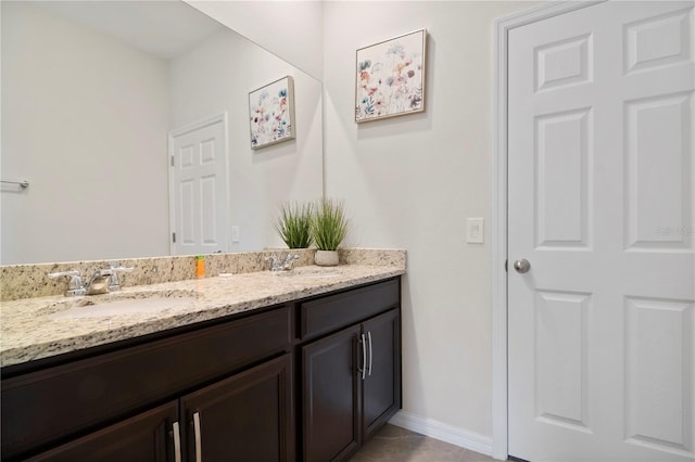 bathroom with dual vanity and tile patterned floors