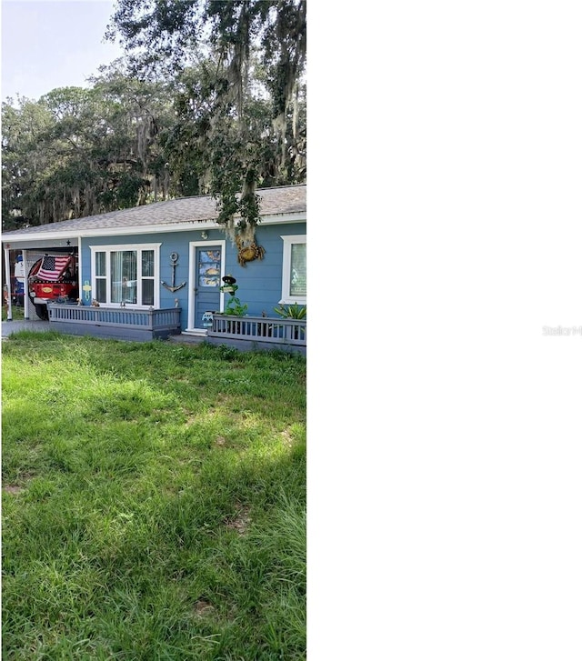 single story home featuring an attached carport and a front yard