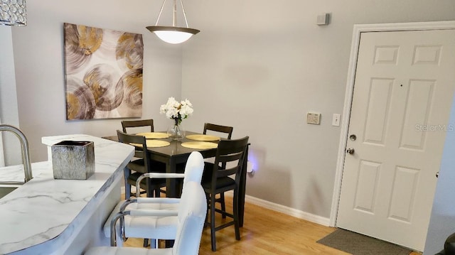 dining area featuring light wood-type flooring