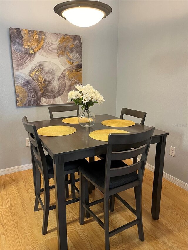 dining space with light hardwood / wood-style floors