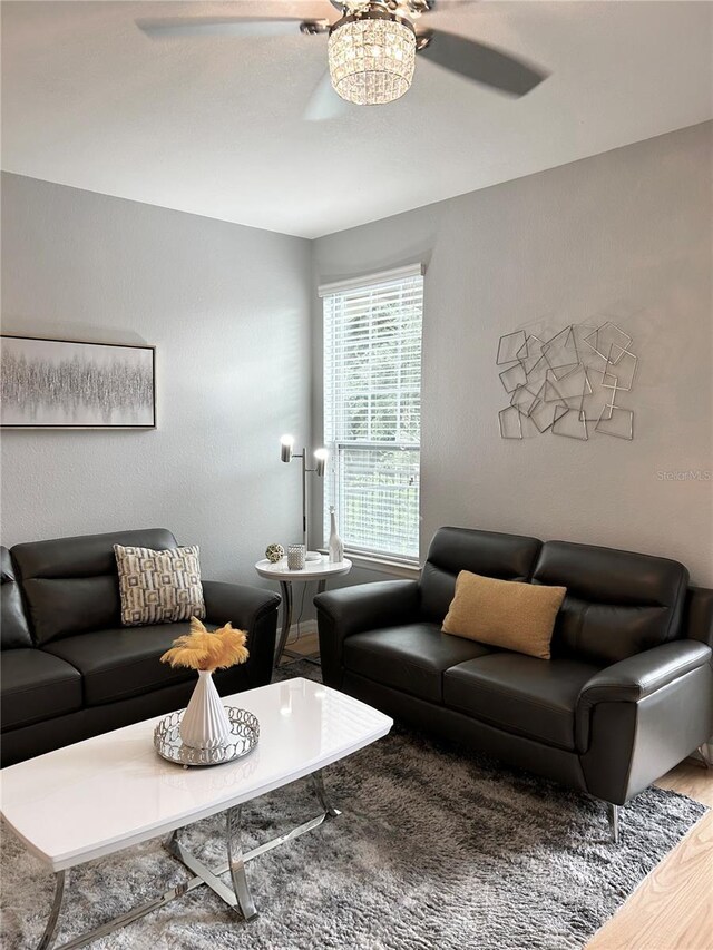 living room featuring ceiling fan and hardwood / wood-style flooring