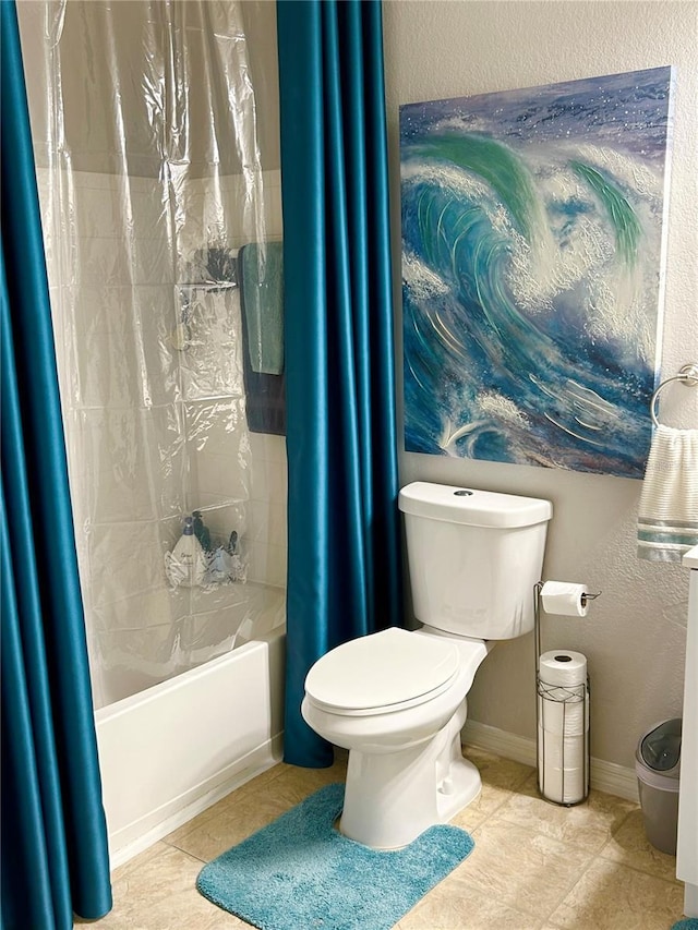 1990 Erving Cir Unit 201, Ocoee, FL 34761 - bathroom featuring toilet, shower / bathtub combination with curtain, tile patterned flooring, baseboards, and a textured wall