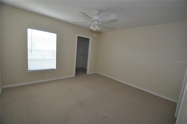 unfurnished room featuring ceiling fan, baseboards, and light carpet