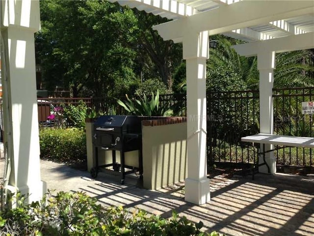 view of patio / terrace featuring a pergola and fence