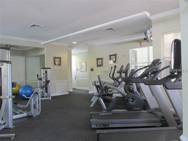 gym featuring visible vents, baseboards, and crown molding