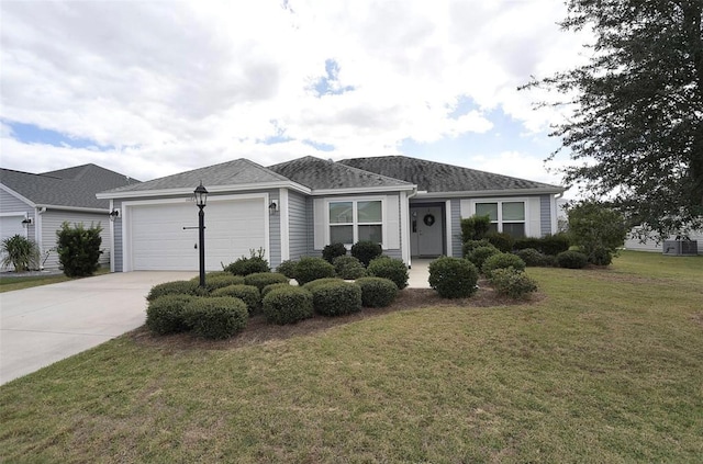 ranch-style house with a garage and a front lawn