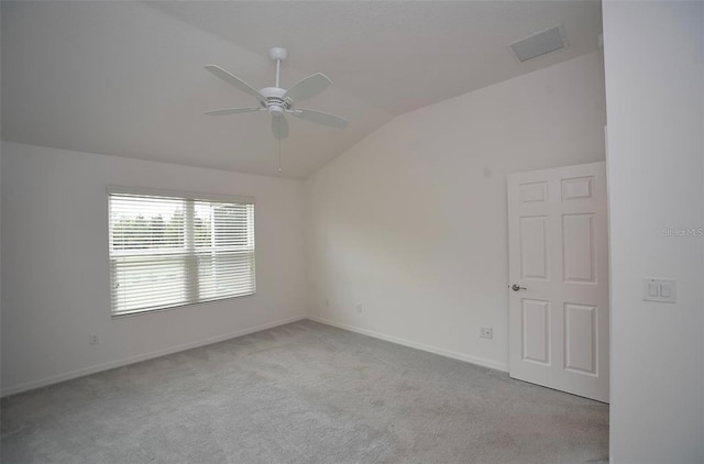 unfurnished room with ceiling fan, carpet flooring, and vaulted ceiling