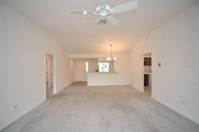 unfurnished living room with lofted ceiling, light colored carpet, and ceiling fan with notable chandelier