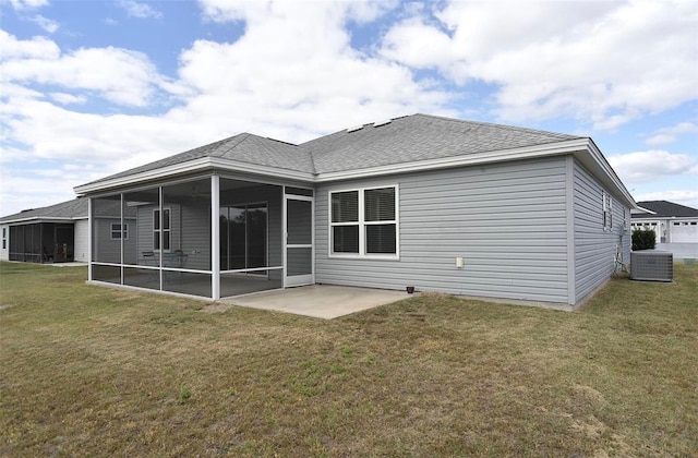 rear view of house with a patio area, a sunroom, and a lawn