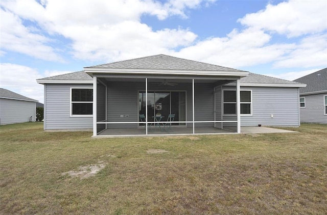 rear view of property featuring a patio, a lawn, and ceiling fan