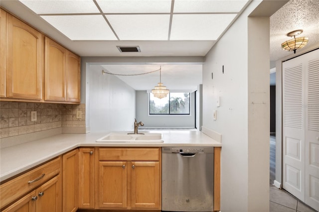 kitchen featuring pendant lighting, sink, stainless steel dishwasher, tasteful backsplash, and light tile patterned flooring