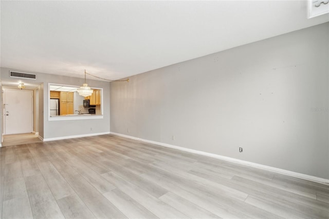 unfurnished living room with light hardwood / wood-style floors