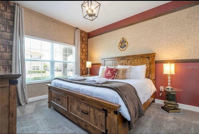 bedroom featuring a chandelier and carpet flooring