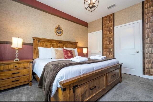 bedroom with carpet flooring and a chandelier