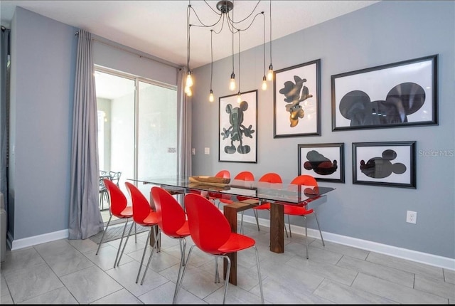 tiled dining room featuring a notable chandelier