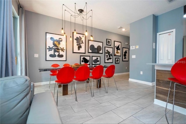 dining area featuring light tile patterned flooring