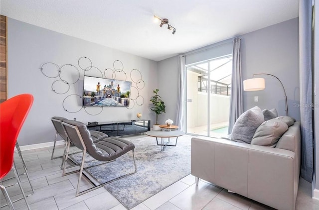 tiled living room featuring rail lighting